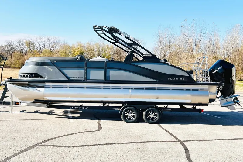 Slide: The Image of 2026 Harris Grand Mariner 230 pontoon boat on trailer, sleek design, outdoor setting. - 5