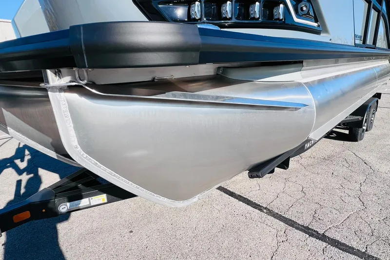 Slide: The Image of 2026 Harris Grand Mariner 230 pontoon boat on trailer, close-up view. - 50
