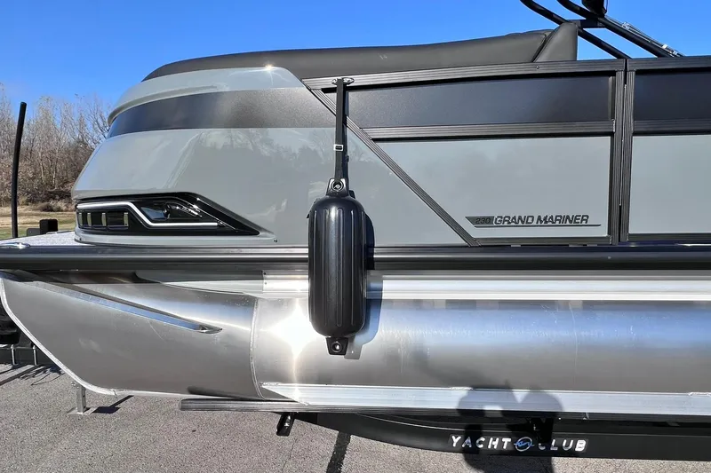 Slide: The Image of 2026 Harris Grand Mariner 230 pontoon boat side view with sleek design and fender. - 56
