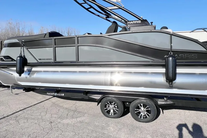 Slide: The Image of 2026 Harris Grand Mariner 230 pontoon boat on trailer, sleek design, black and silver finish. - 58