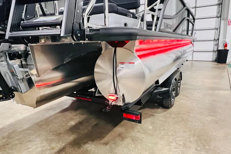Slide: The Image of 2026 Harris Grand Mariner 230 pontoon boat on trailer in a garage setting. - 61