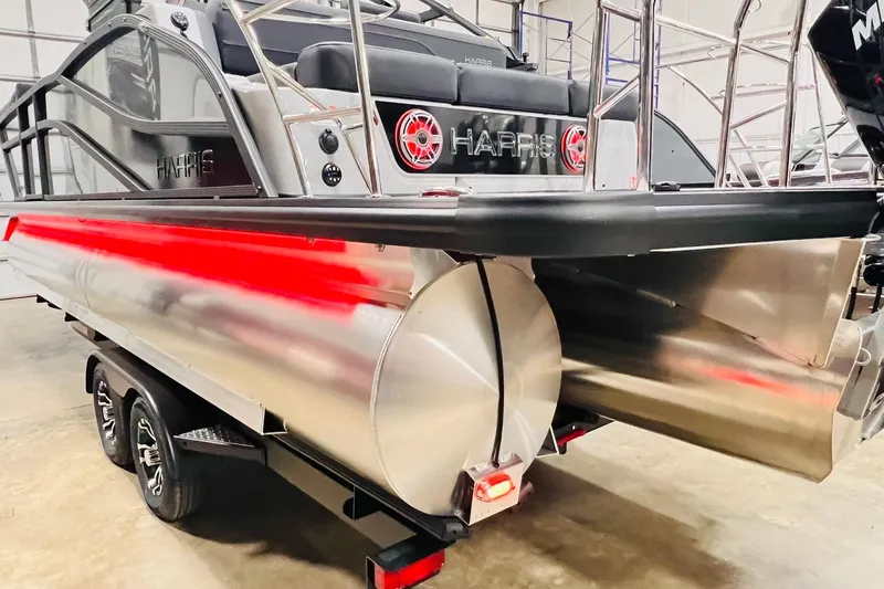 Slide: The Image of 2026 Harris Grand Mariner 230 pontoon boat on trailer, showcasing sleek design and modern features. - 63