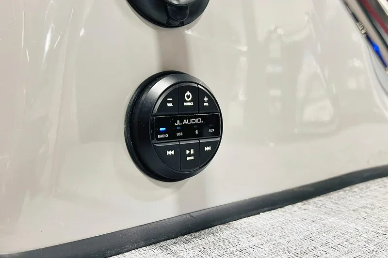 Slide: The Image of JL Audio control panel on 2026 Harris Grand Mariner 230 boat dashboard. - 65