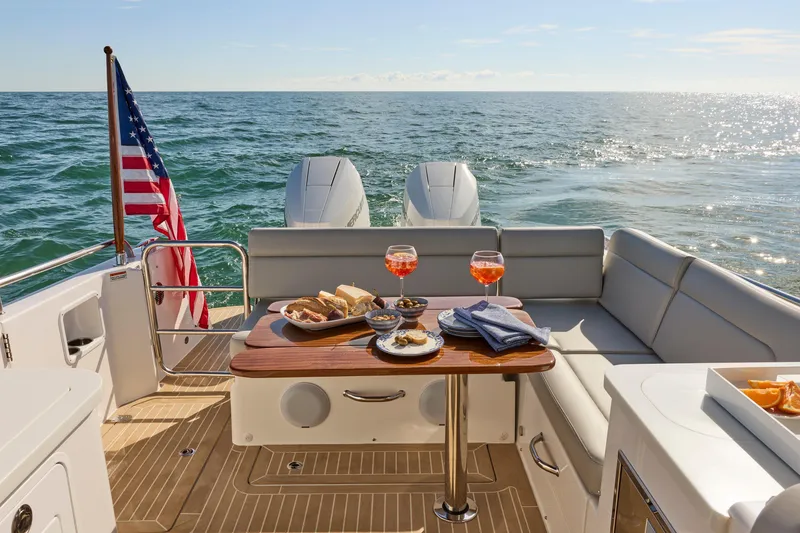 Slide: The Image of 2026 MJM 38 X boat cruising near a marina with a clock tower. - 1