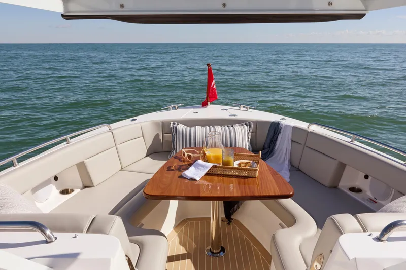 Slide: The Image of Luxurious 2026 MJM 38 X yacht interior with ocean view, featuring a dining area and navigation controls. - 16