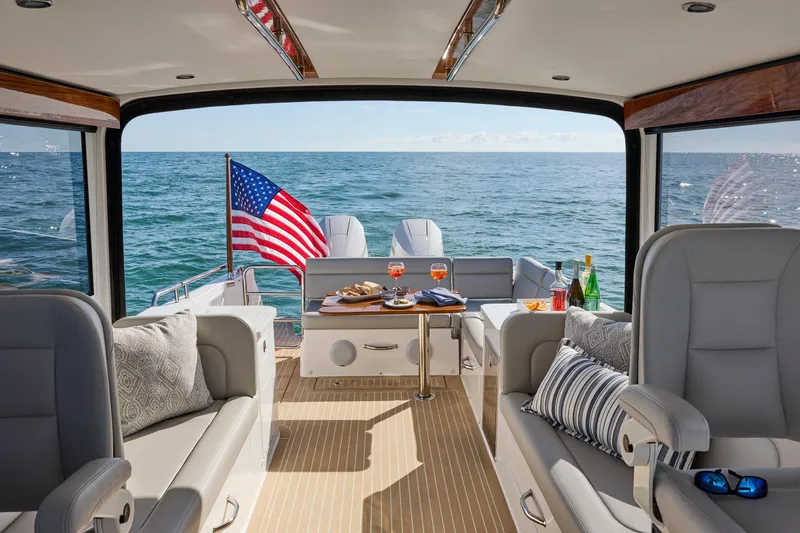 Slide: The Image of Luxurious 2026 MJM 38 X yacht interior with elegant seating, table, and ocean view. - 5