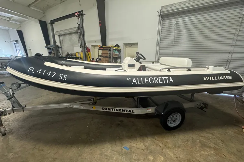 Slide: The Image of 2020 Williams Jet Tenders Sportjet 435 on trailer in a garage setting. - 2