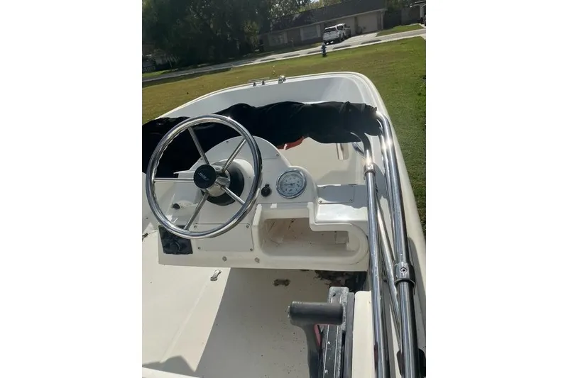 Slide: The Image of 2010 Boston Whaler 13 Dauntless boat interior with steering wheel and gauge. - 2