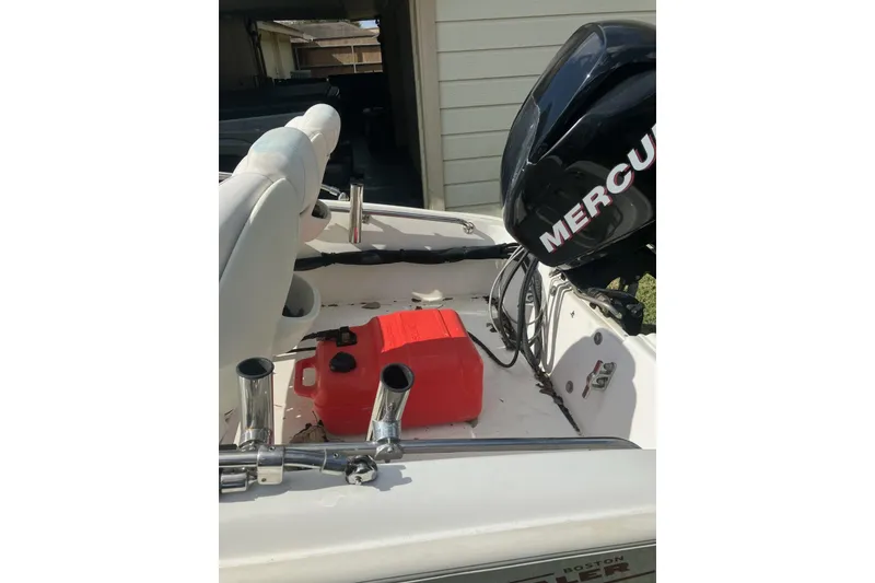 Slide: The Image of 2010 Boston Whaler 13 Dauntless boat with Mercury engine and red fuel tank. - 5