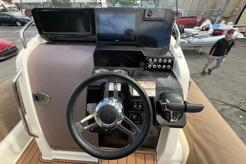 Slide: The Image of 2024 Zodiac Medline 9 boat dashboard with steering wheel and control panel. - 1