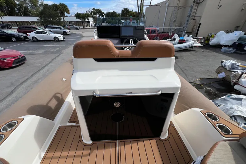 Slide: The Image of 2024 Zodiac Medline 9 boat interior with brown seating and modern dashboard. - 3