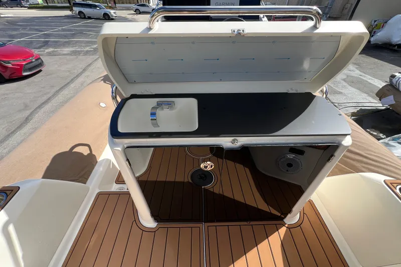 Slide: The Image of 2024 Zodiac Medline 9 boat interior with sink and wooden deck. - 4