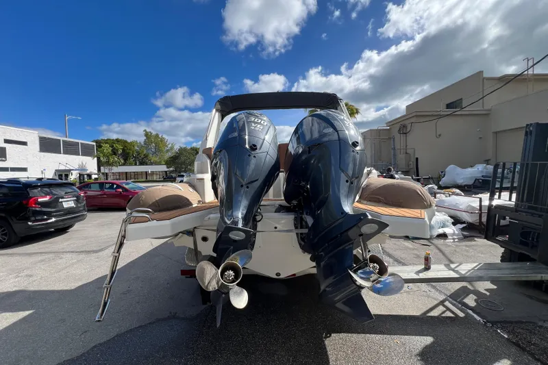 Slide: The Image of 2024 Zodiac Medline 9 boat with dual outboard engines in a parking area. - 7