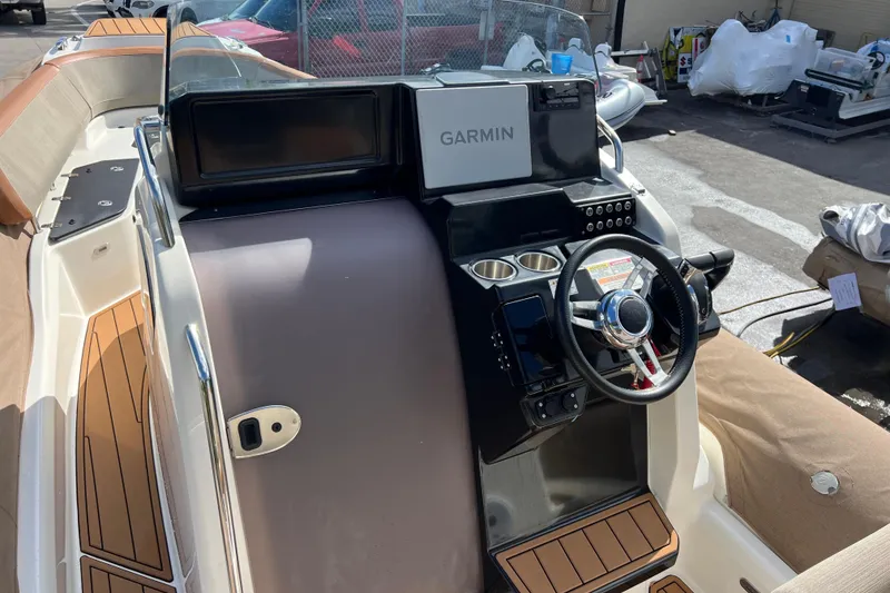 Slide: The Image of 2024 Zodiac Medline 9 boat dashboard with Garmin navigation system and steering wheel. - 8