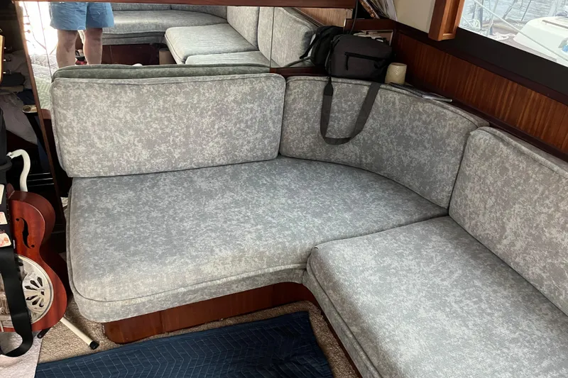 Slide: The Image of Interior of 1987 Hatteras 41 Convertible with gray cushioned seating and wooden accents. - 11