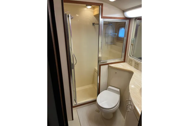Slide: The Image of Bathroom interior of 1987 Hatteras 41 Convertible yacht, featuring shower and toilet. - 12