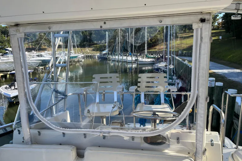 Slide: The Image of 1987 Hatteras 41 Convertible yacht docked at a marina, view from the helm. - 13