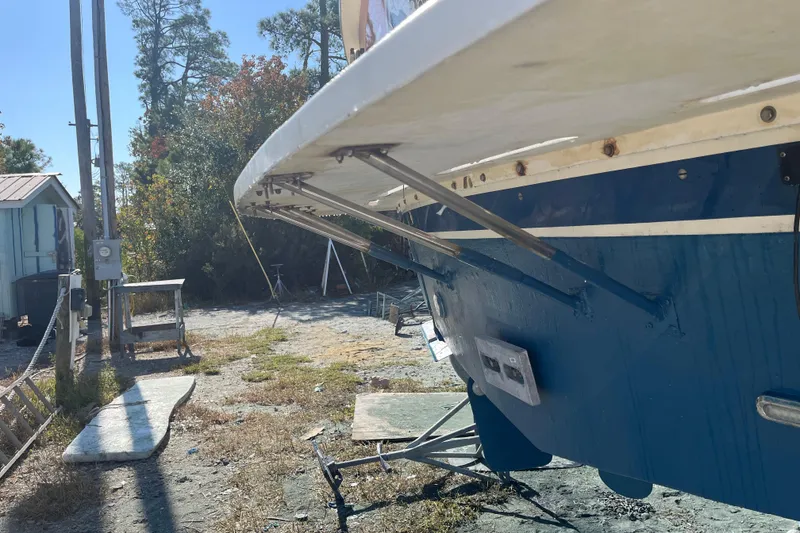 Slide: The Image of 1987 Hatteras 41 Convertible boat on dry land, showing hull and trim tabs. - 16