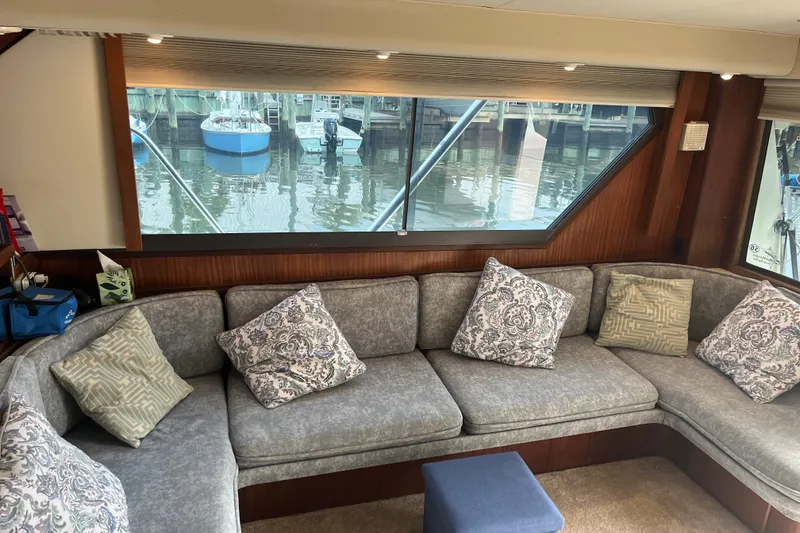 Slide: The Image of Interior of 1987 Hatteras 41 Convertible yacht with cozy seating and decorative pillows. - 4