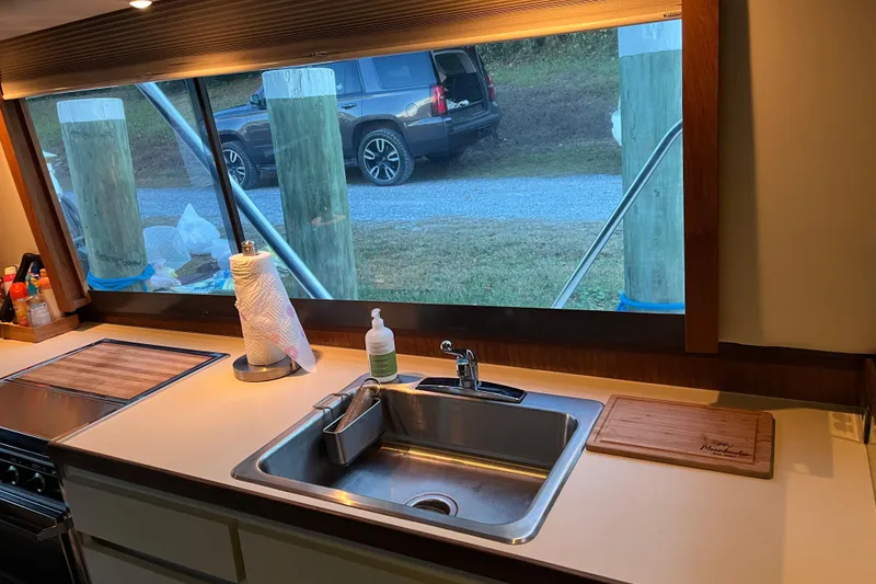 Slide: The Image of Interior of 1987 Hatteras 41 Convertible yacht kitchen with sink and window view. - 9