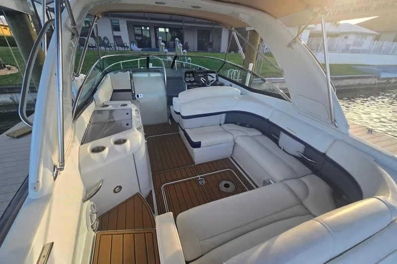 Slide: The Image of 2013 Formula 310 Sun Sport boat interior with luxurious seating and wooden flooring. - 13
