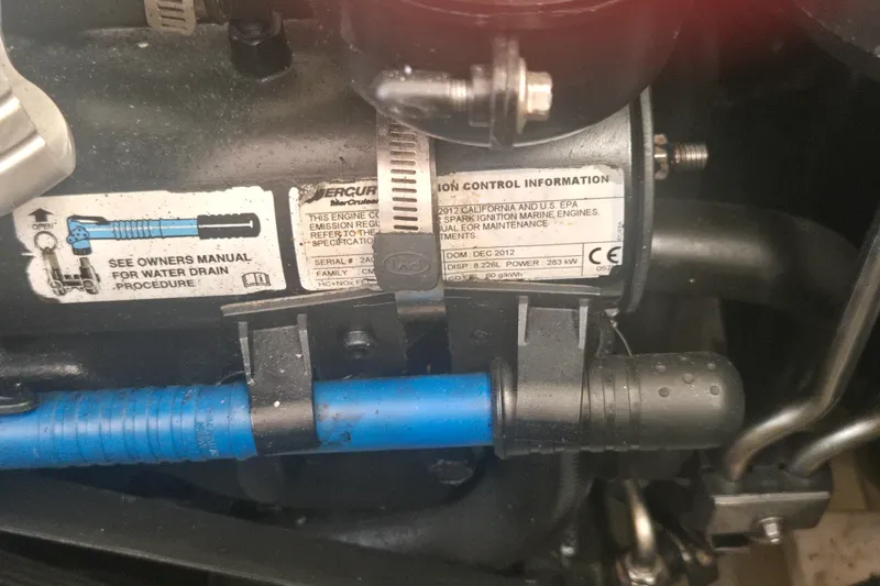 Slide: The Image of Engine compartment of a 2013 Formula 310 Sun Sport with emission control information. - 15