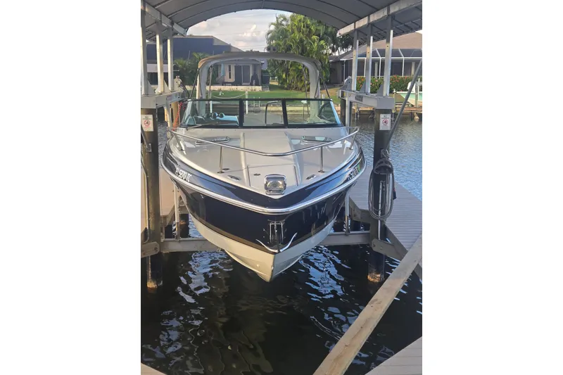 Slide: The Image of 2013 Formula 310 Sun Sport boat docked under a covered lift. - 2