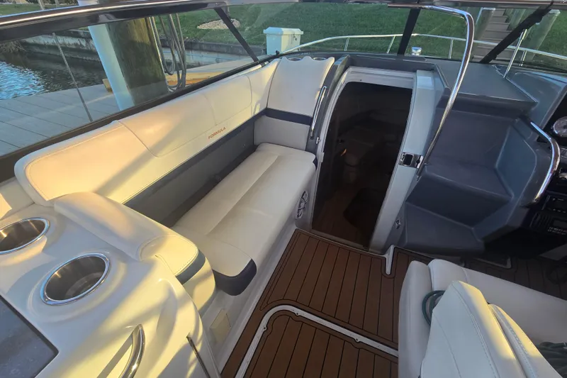 Slide: The Image of 2013 Formula 310 Sun Sport boat interior with seating and cup holders. - 27