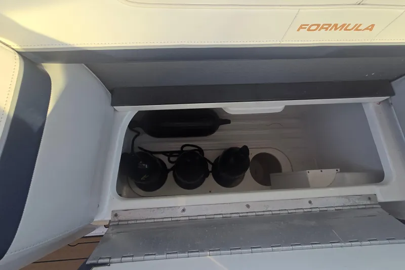 Slide: The Image of Storage compartment in a 2013 Formula 310 Sun Sport boat with equipment inside. - 28