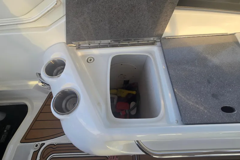 Slide: The Image of 2013 Formula 310 Sun Sport boat interior with storage compartment and cup holders. - 30
