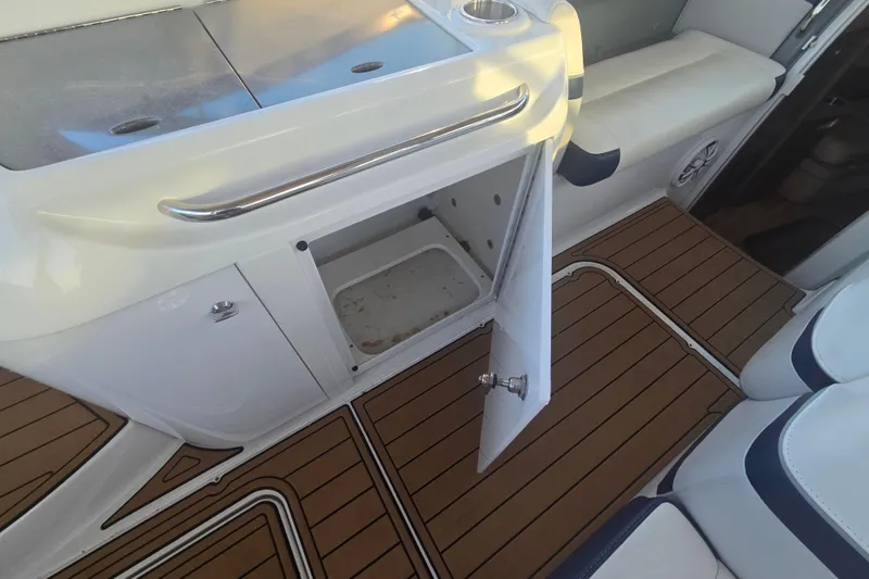 Slide: The Image of 2013 Formula 310 Sun Sport boat interior with open storage compartment and teak flooring. - 32