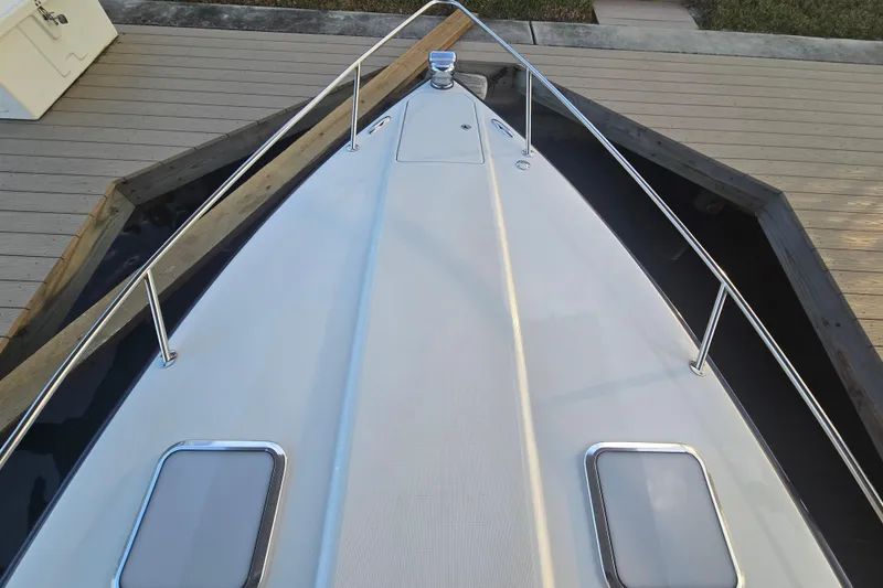 Slide: The Image of 2013 Formula 310 Sun Sport boat bow view at dock, featuring sleek design and railings. - 35