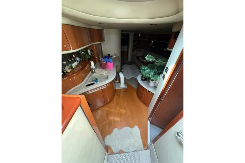 Slide: The Image of Interior of 2000 Sea Ray Sundancer 540 yacht with kitchen and lounge area. - 13