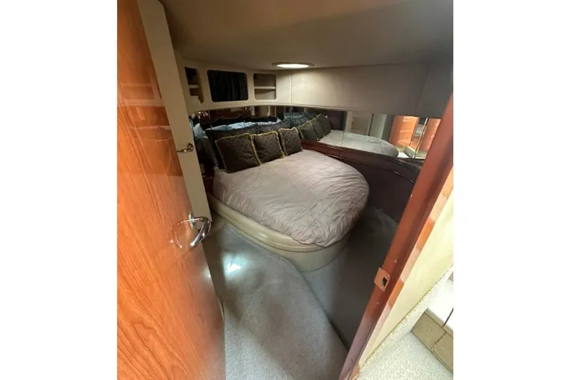 Slide: The Image of Cozy bedroom interior of 2000 Sea Ray Sundancer 540 yacht with plush bedding. - 14