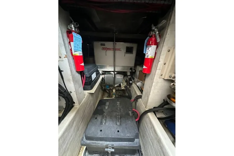 Slide: The Image of Engine room of 2000 Sea Ray Sundancer 540 with fire extinguishers and equipment. - 17