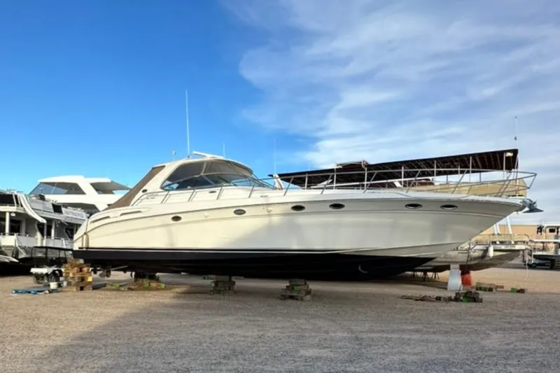 Slide: The Image of 2000 Sea Ray Sundancer 540 yacht on dry dock under a clear blue sky. - 18