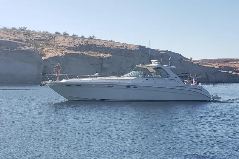 Slide: The Image of 2000 Sea Ray Sundancer 540 cruising on a scenic lake with rocky shoreline. - 5