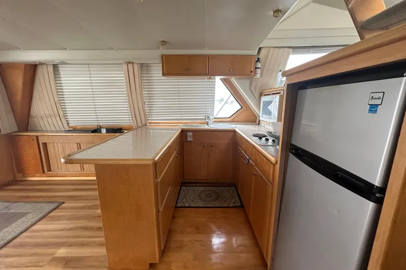 Slide: The Image of Kitchen interior of 1996 Navigator 53 Classic yacht with wood cabinetry and modern appliances. - 10