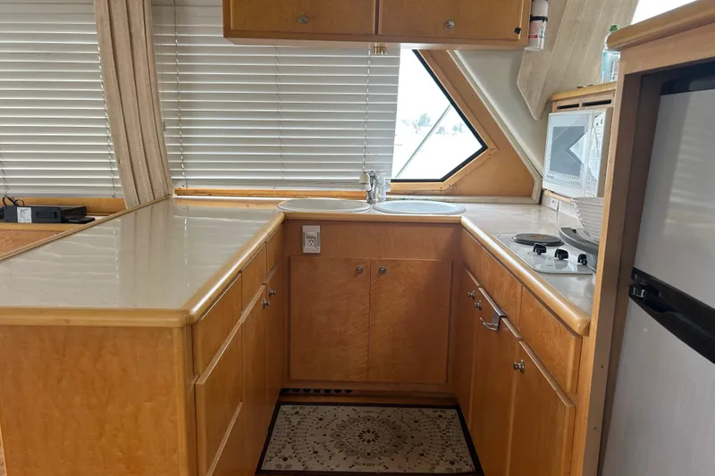 Slide: The Image of Interior of 1996 Navigator 53 Classic yacht kitchen with wood cabinetry and modern appliances. - 11