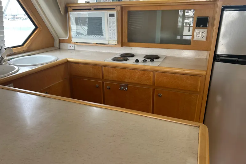 Slide: The Image of 1996 Navigator 53 Classic yacht kitchen with stove, microwave, and sink. - 12