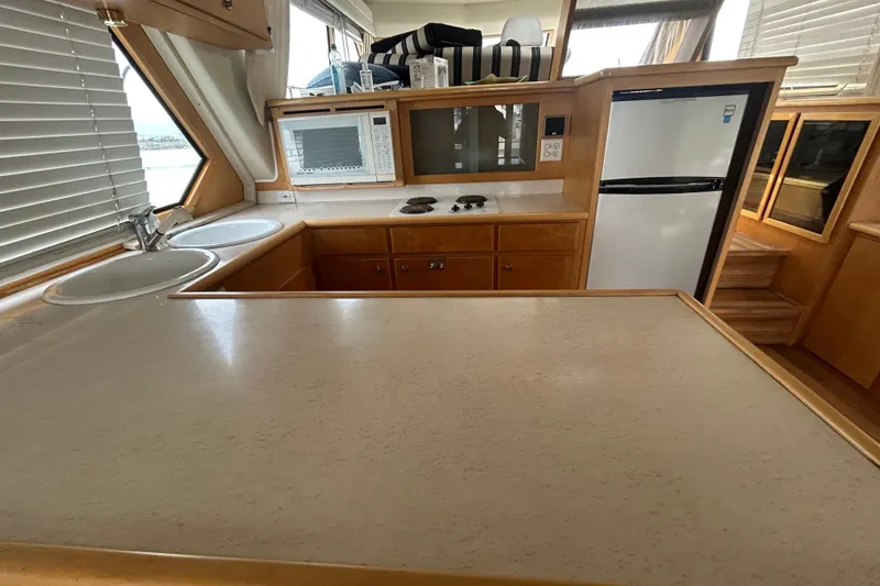 Slide: The Image of Kitchen area of 1996 Navigator 53 Classic yacht with sink, stove, and refrigerator. - 14