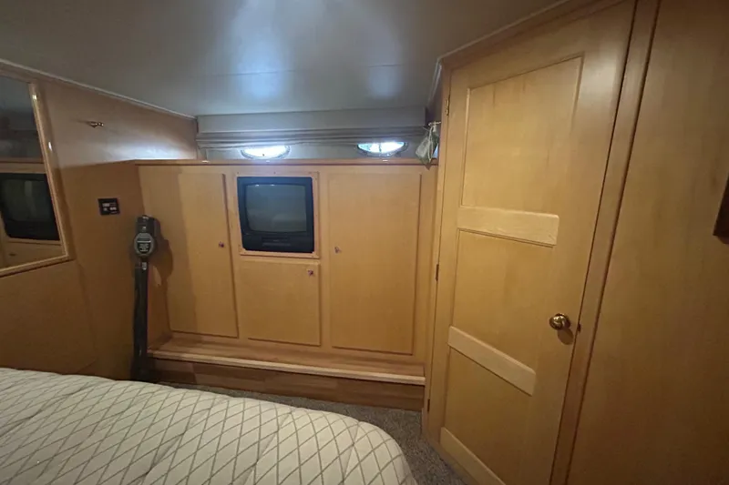 Slide: The Image of Interior of 1996 Navigator 53 Classic yacht with wood paneling and built-in TV. - 18