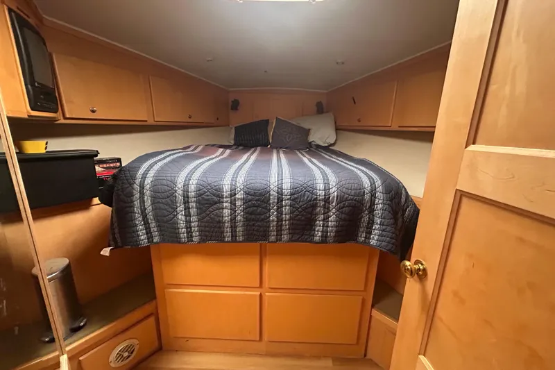 Slide: The Image of Cozy bedroom in 1996 Navigator 53 Classic yacht with striped bedding and wooden cabinets. - 20