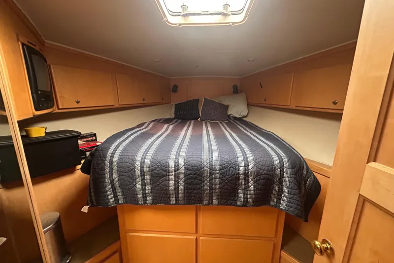 Slide: The Image of Cozy bedroom in 1996 Navigator 53 Classic yacht with striped bedding and wooden cabinets. - 21