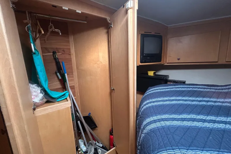 Slide: The Image of 1996 Navigator 53 Classic interior with closet, bed, and vintage TV. - 22