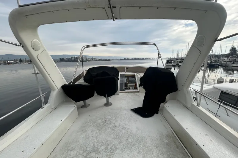 Slide: The Image of 1996 Navigator 53 Classic yacht deck with marina view, overcast sky. - 26