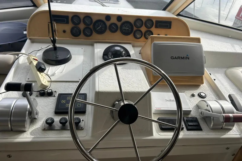 Slide: The Image of Navigator 53 Classic 1996 yacht helm with Garmin navigation system and steering wheel. - 29