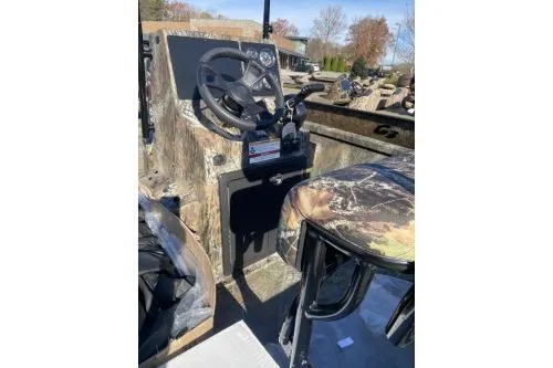 Slide: The Image of 2026 G3 Bay 19 GX boat console with camo seat and steering wheel. - 5