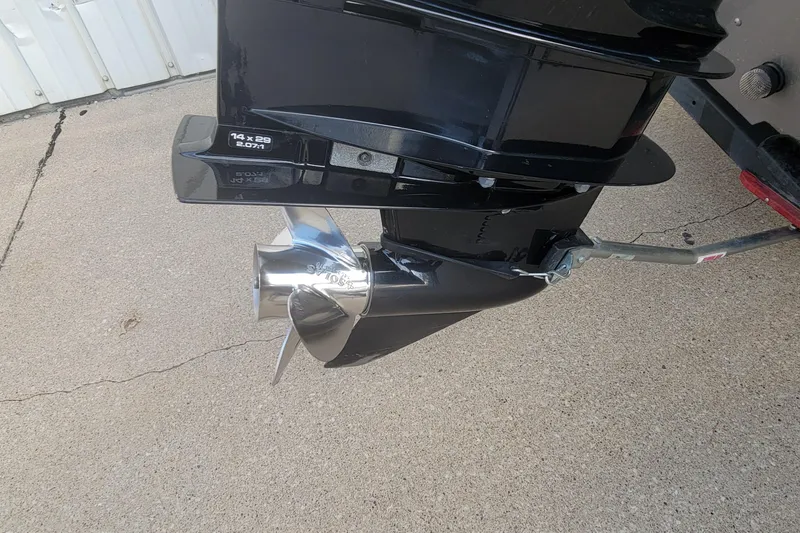 Slide: The Image of 2022 Crestliner 1750 Fish Hawk WT boat motor and propeller on concrete surface. - 11