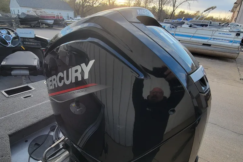 Slide: The Image of 2022 Crestliner 1750 Fish Hawk WT with Mercury outboard engine, parked near other boats. - 12